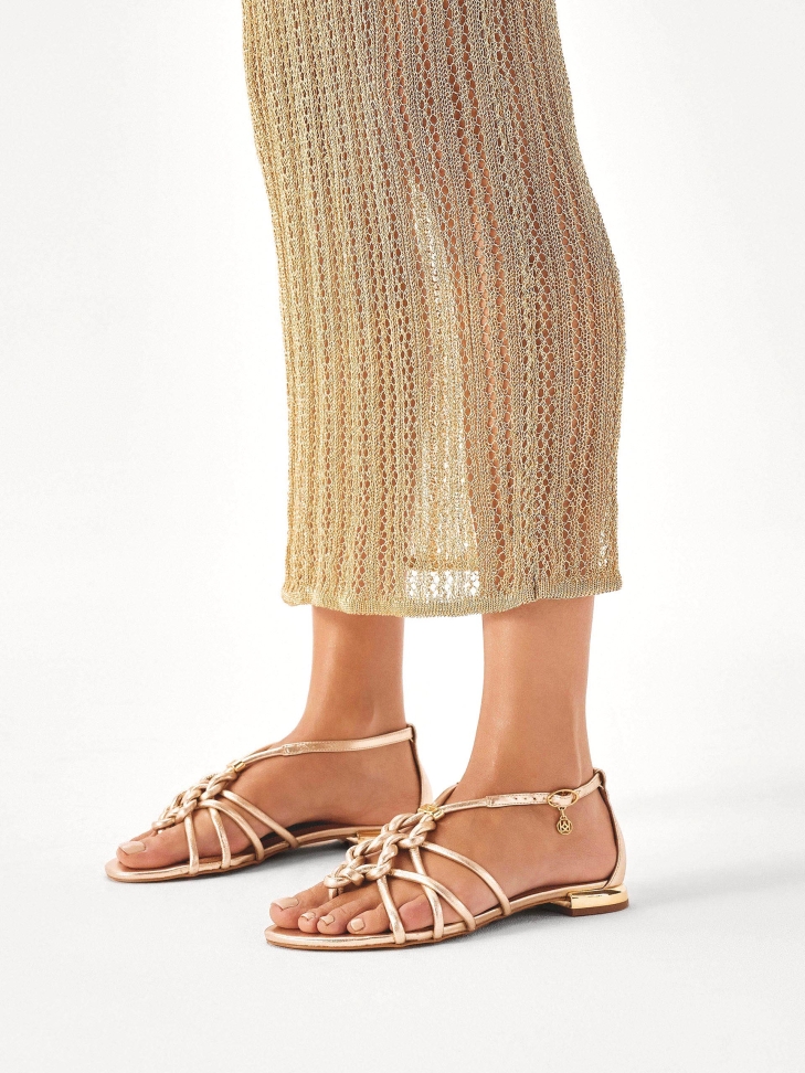 Gold flip flop sandals with intertwined straps