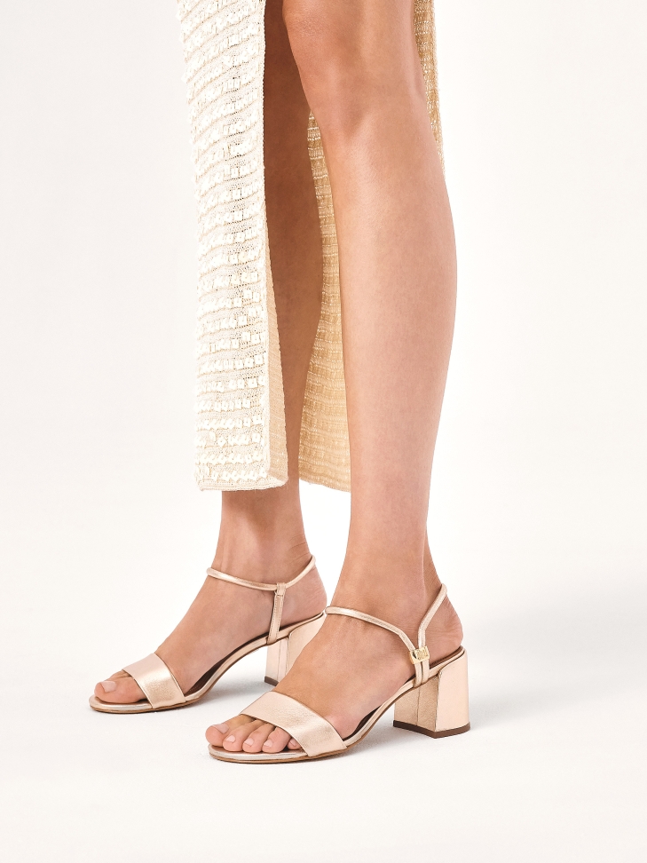 Gold sandals with unique fastening