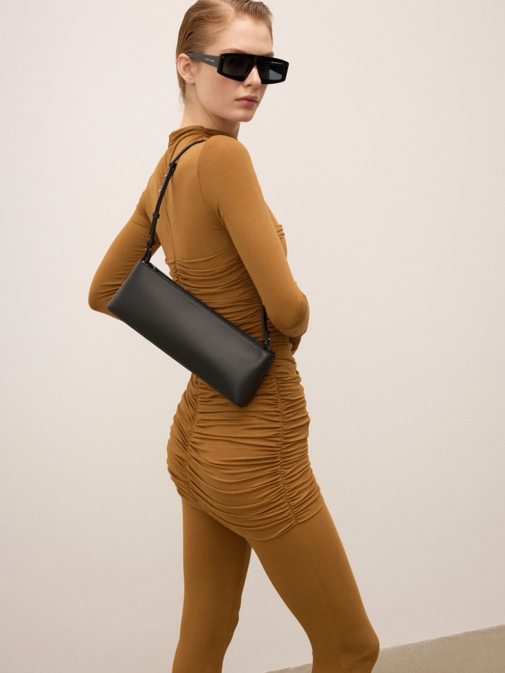 Elongated black handbag with shoulder strap