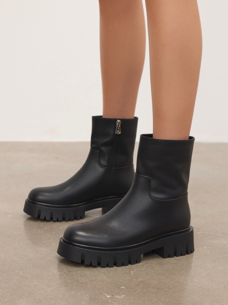 Black natural leather boots on a solid sole