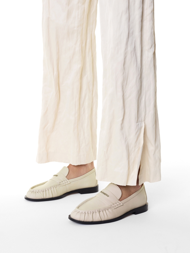 Beige loafers with a crease on the nose