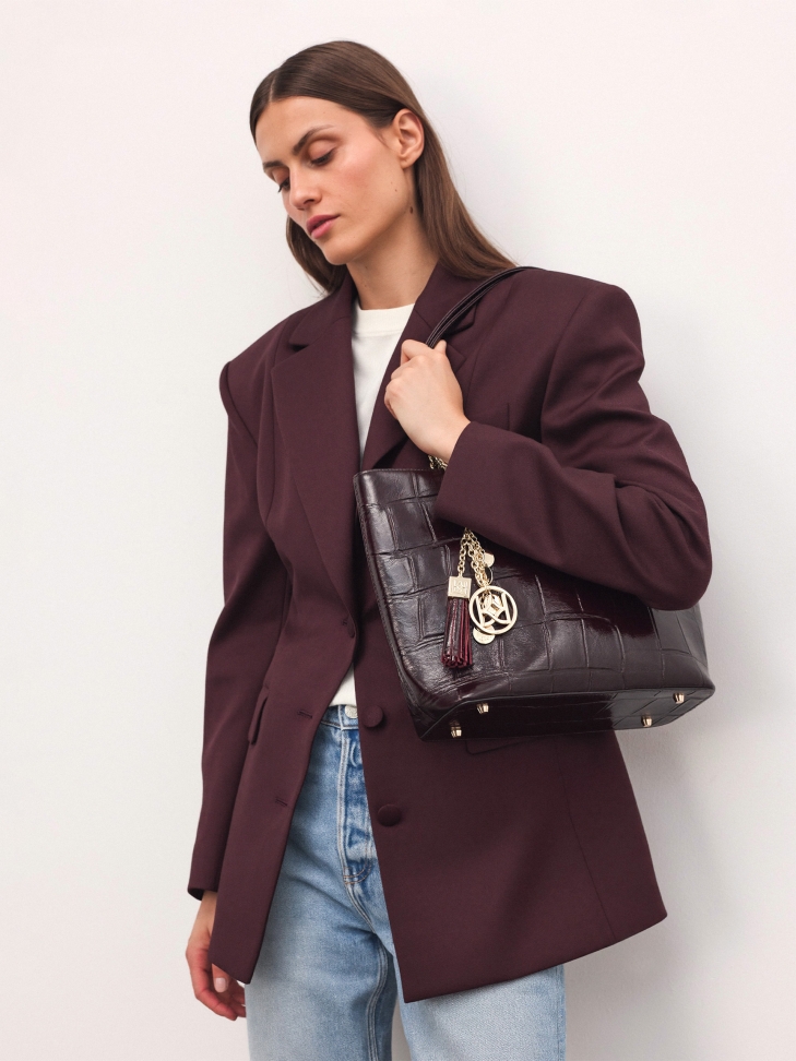 Elegant burgundy handbag with embossed pattern