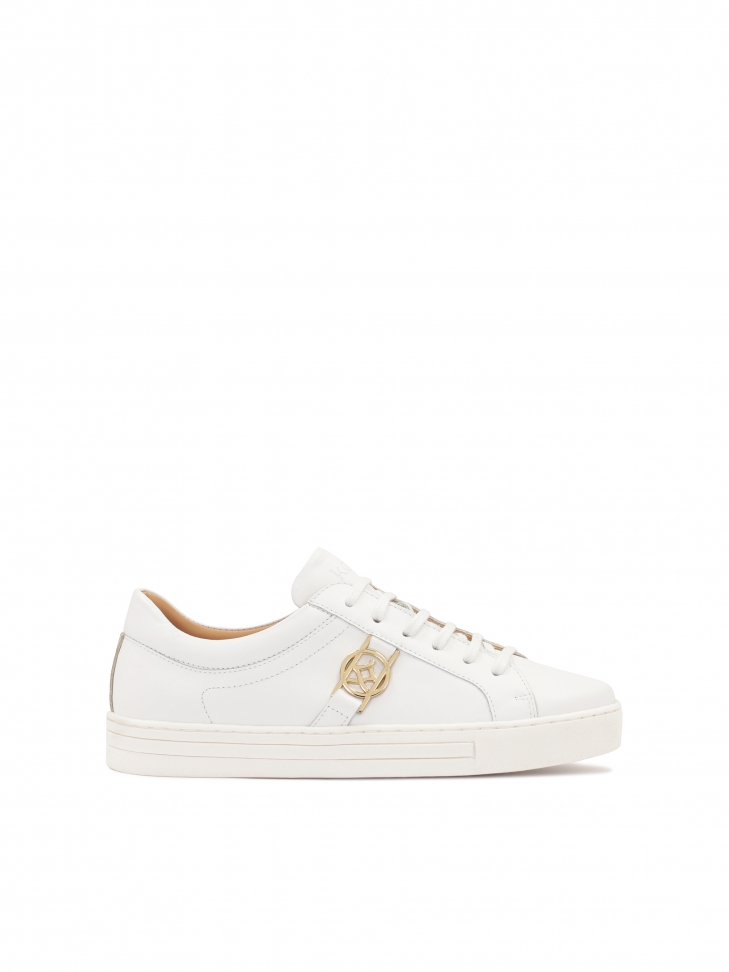 White leather sneakers with golden elements