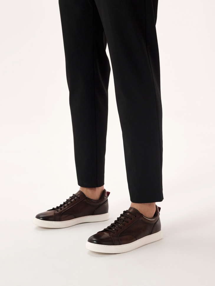 Brown leather sneakers on a white sole