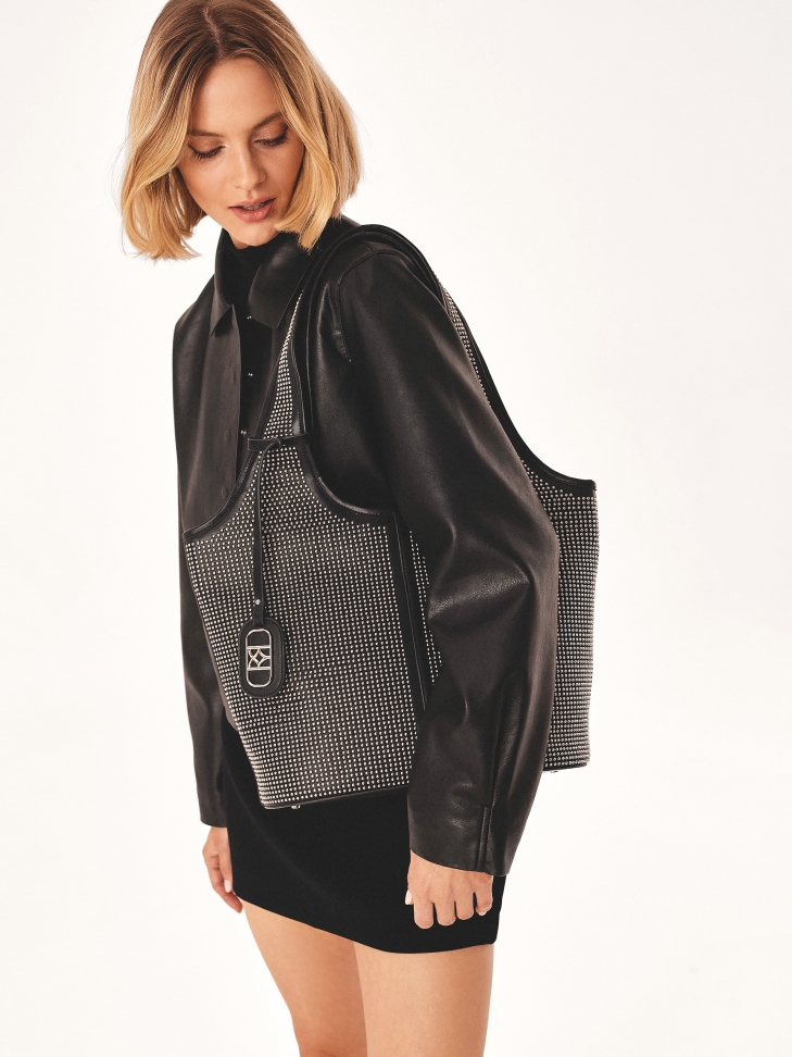 Hobo bag decorated with small metal rivets