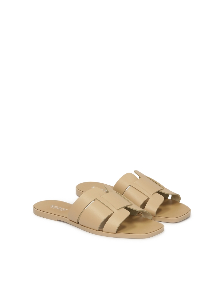Beige natural leather slides with a minimalist design