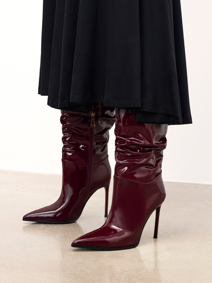 Maroon boots on a slender stiletto heel