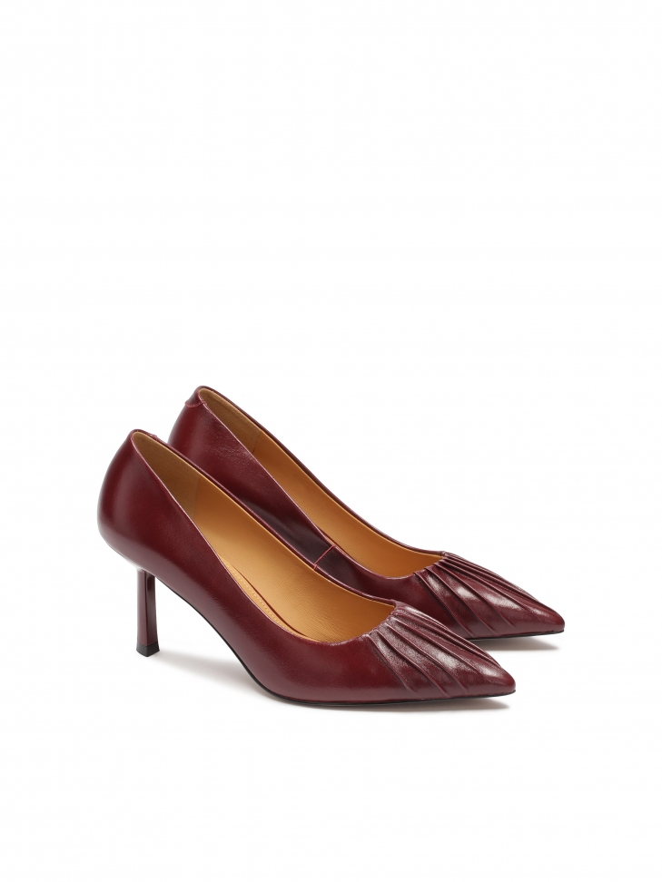 Maroon pumps with a striking notch on the nose