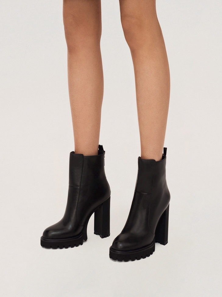 Leather booties with high heel and zip at the back of the upper