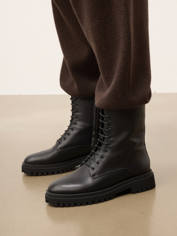 Classic black boots on a trefoil sole