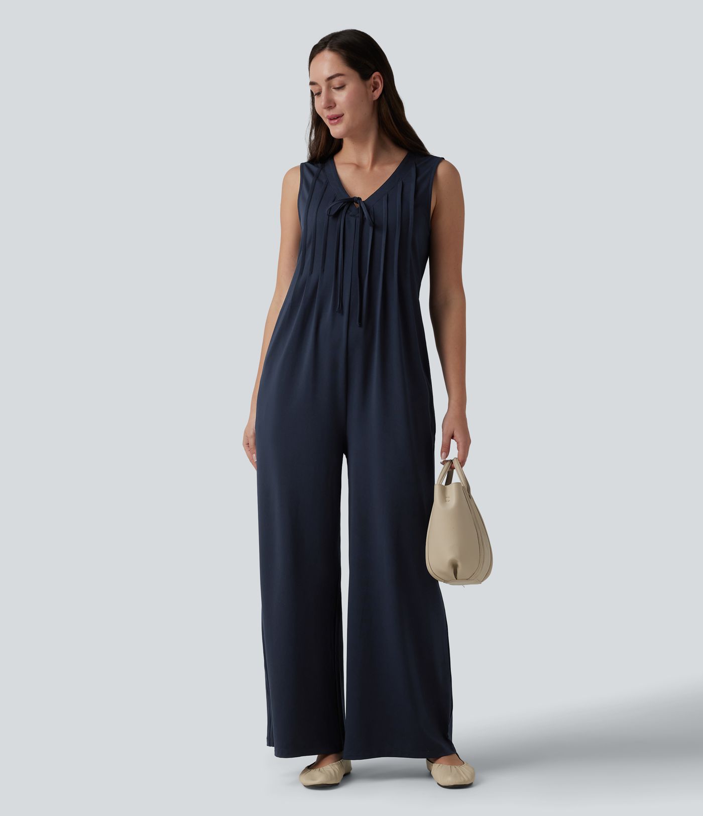 Combinaison casual ample décolleté plongeant sans manches plissée à nœud devant et fermeture éclair invisible avec poches