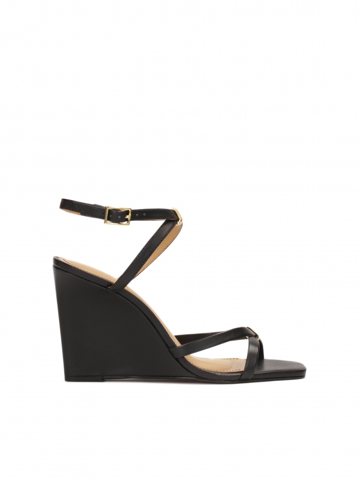 Leather sandals on a platform with crossed straps