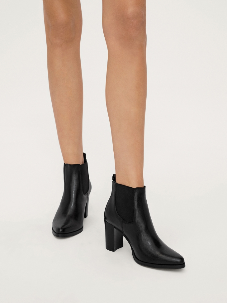 Black minimalistic booties with elastic rubbers in the upper