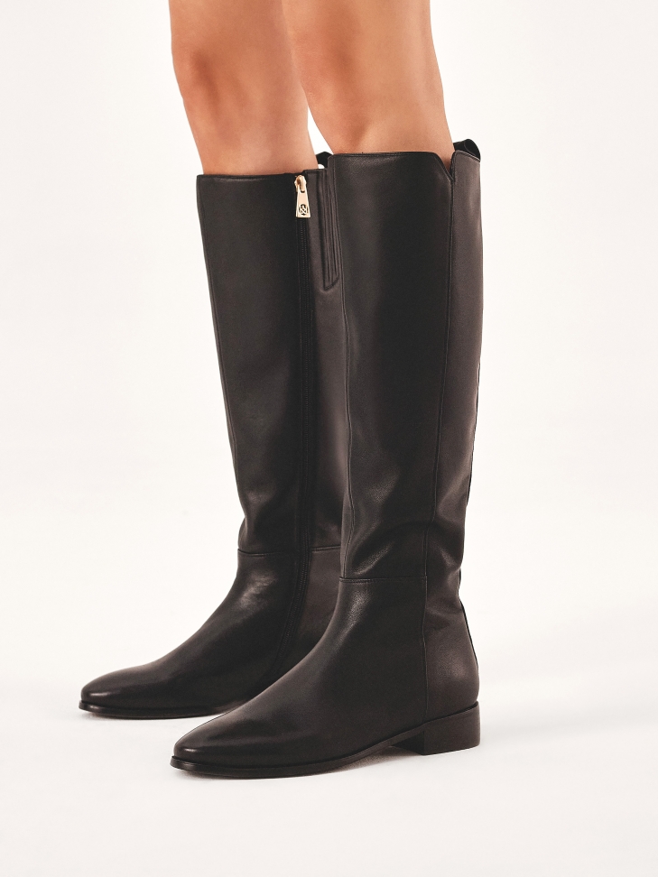 Black leather boots with a cutout on the upper