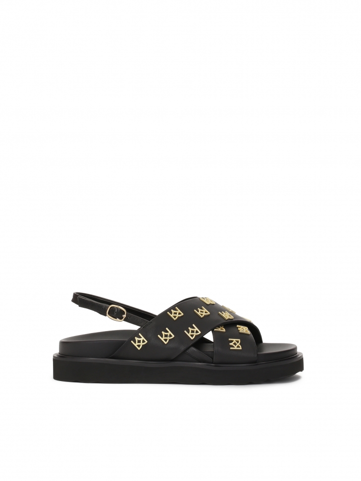 Flat sandals decorated with metal monograms