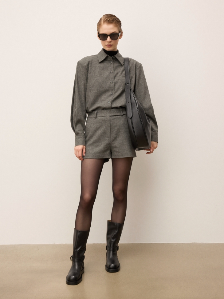 Black leather handbag in the shape of a horn