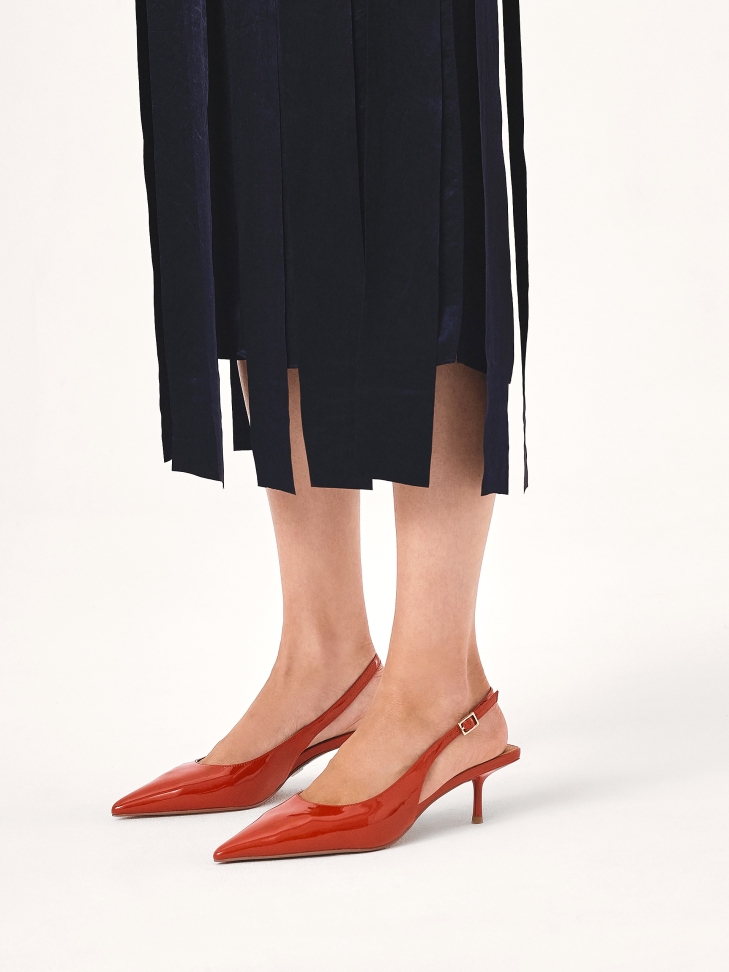 Red patent leather pumps with exposed heel