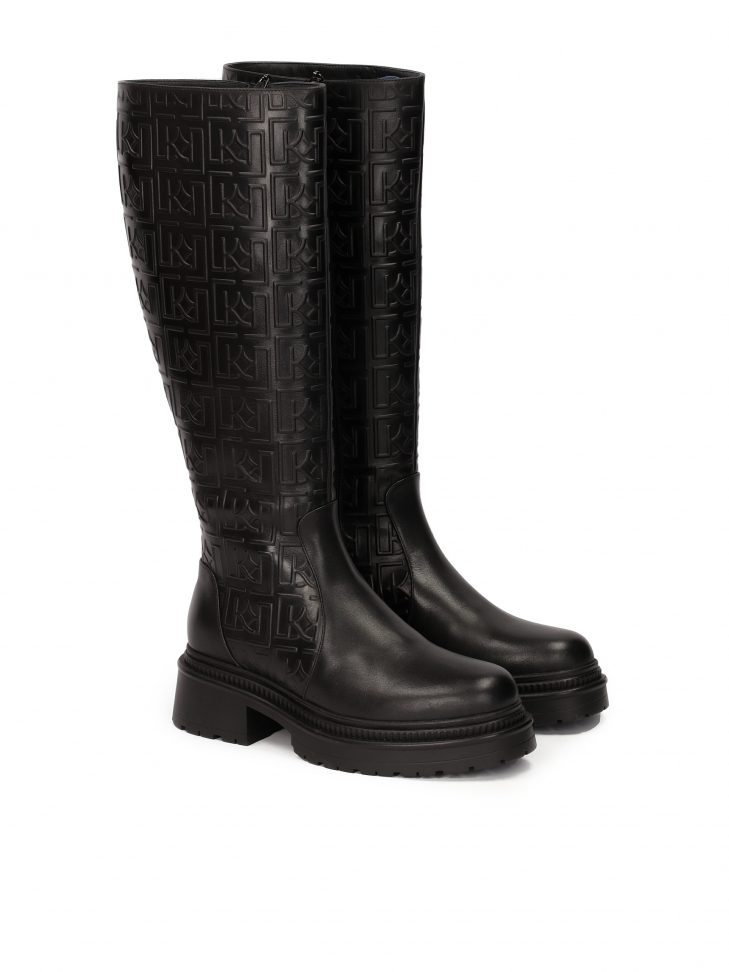Leather boots embellished with embossed pattern