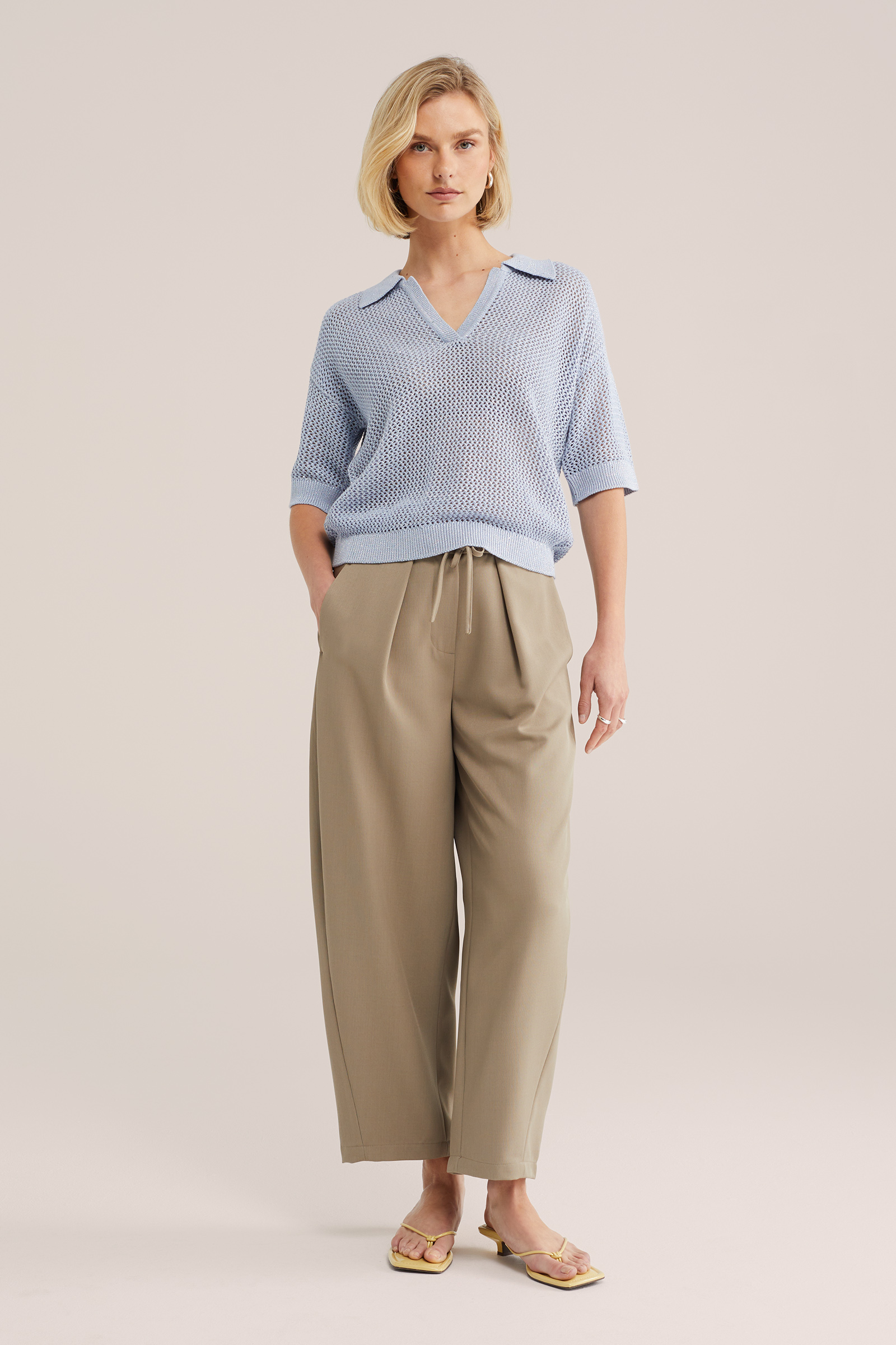 Dames gebreide polo met opengewerkte structuur