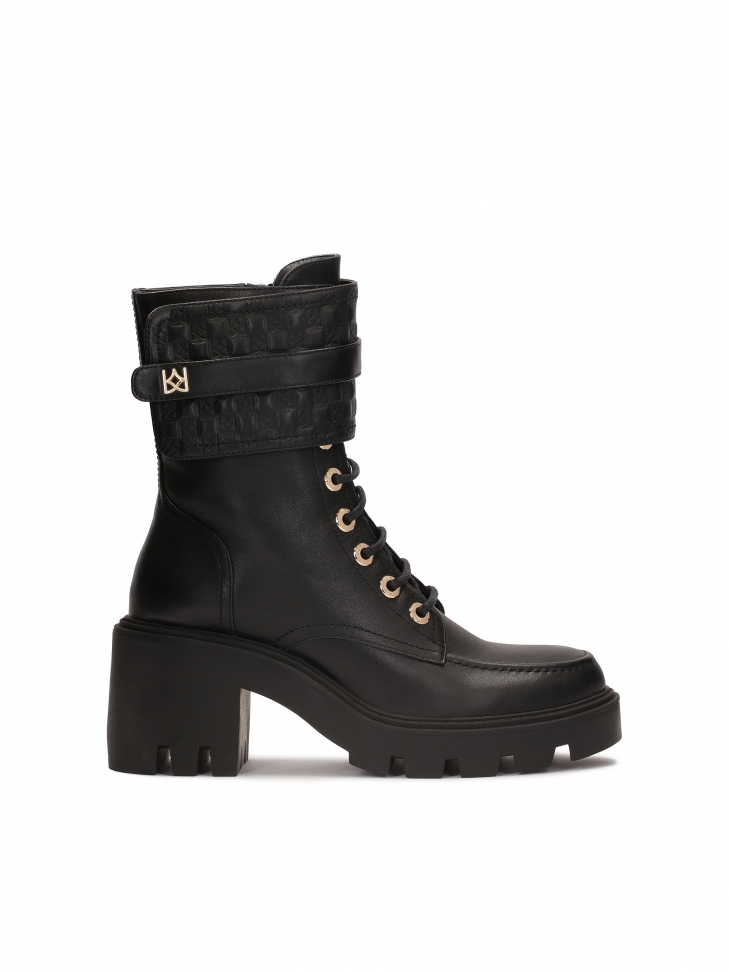 Black block toe boots with monogrammed flap by KAZAR