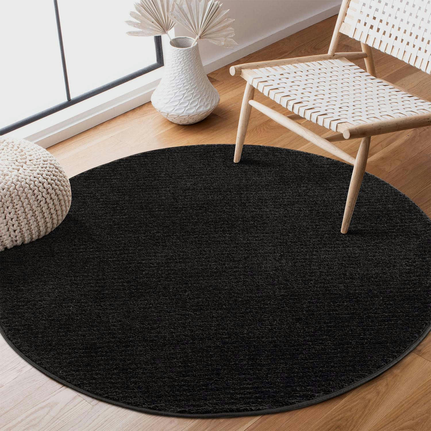 TARA - Tapis rond uni noir à relief linéaire 120x120cm