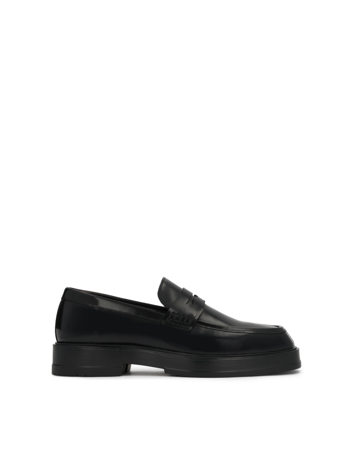 Black slip-on loafers on a higher sole