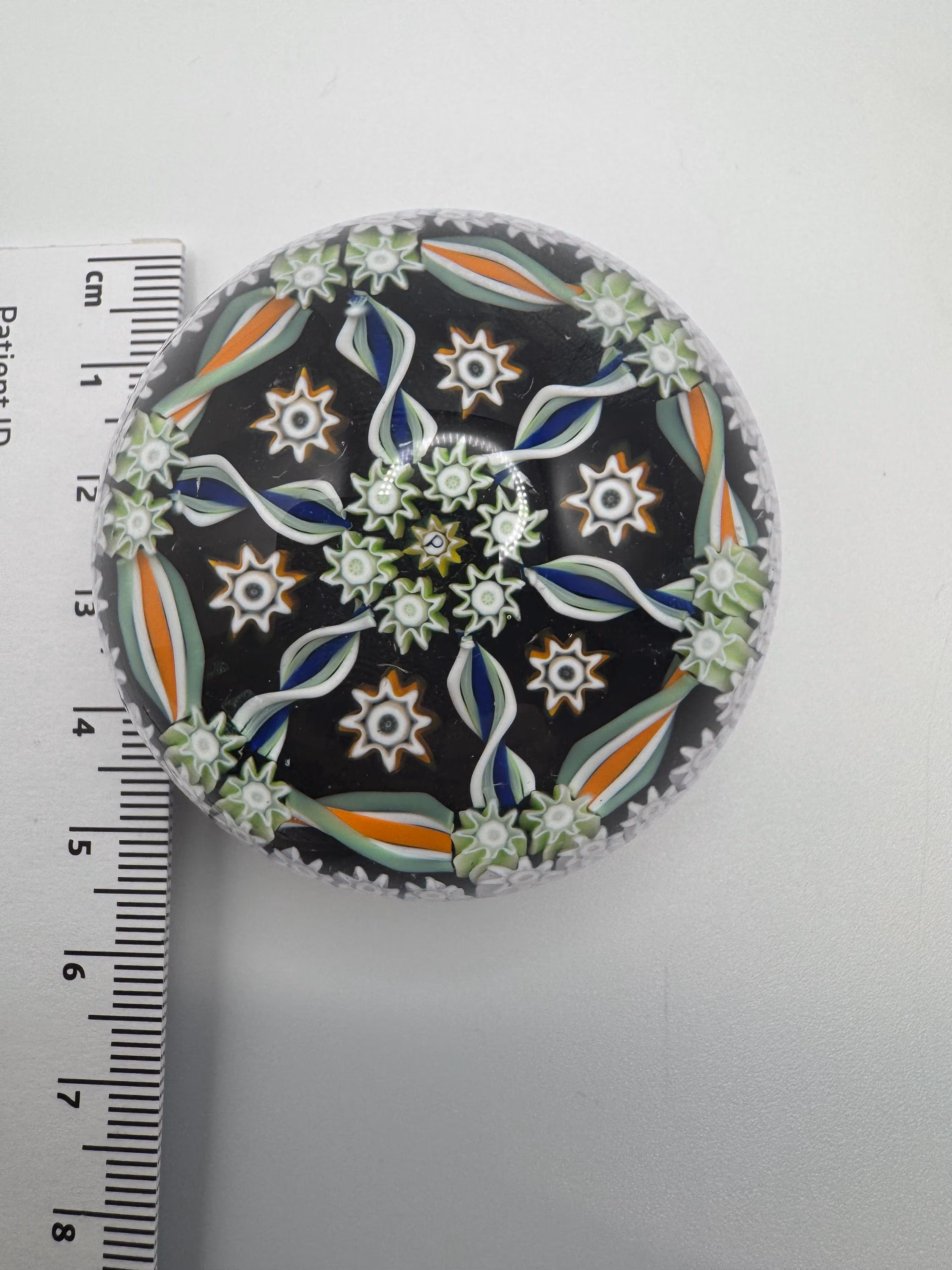 Vintage Perthshire small millefiori glass Paperweight. Brown base with oranges and greens. very good condition.