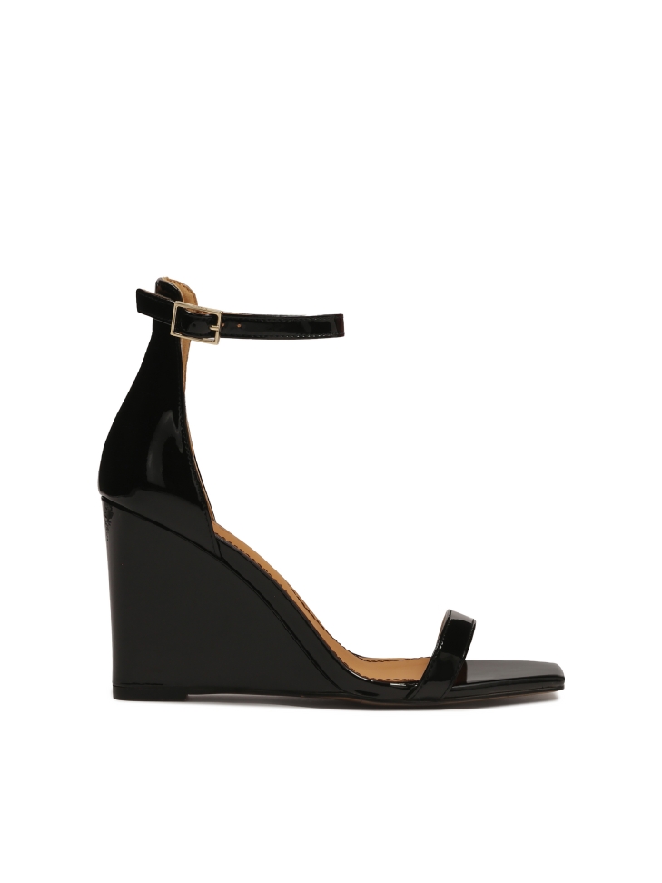 Black patent leather sandals on a heel