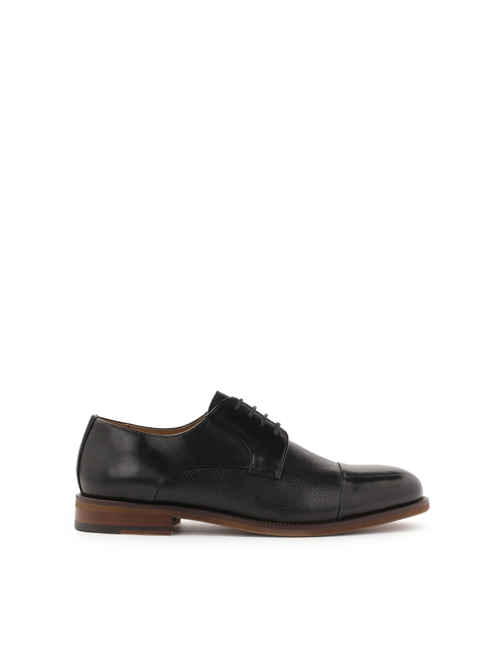 Classic black shoes on a brown sole