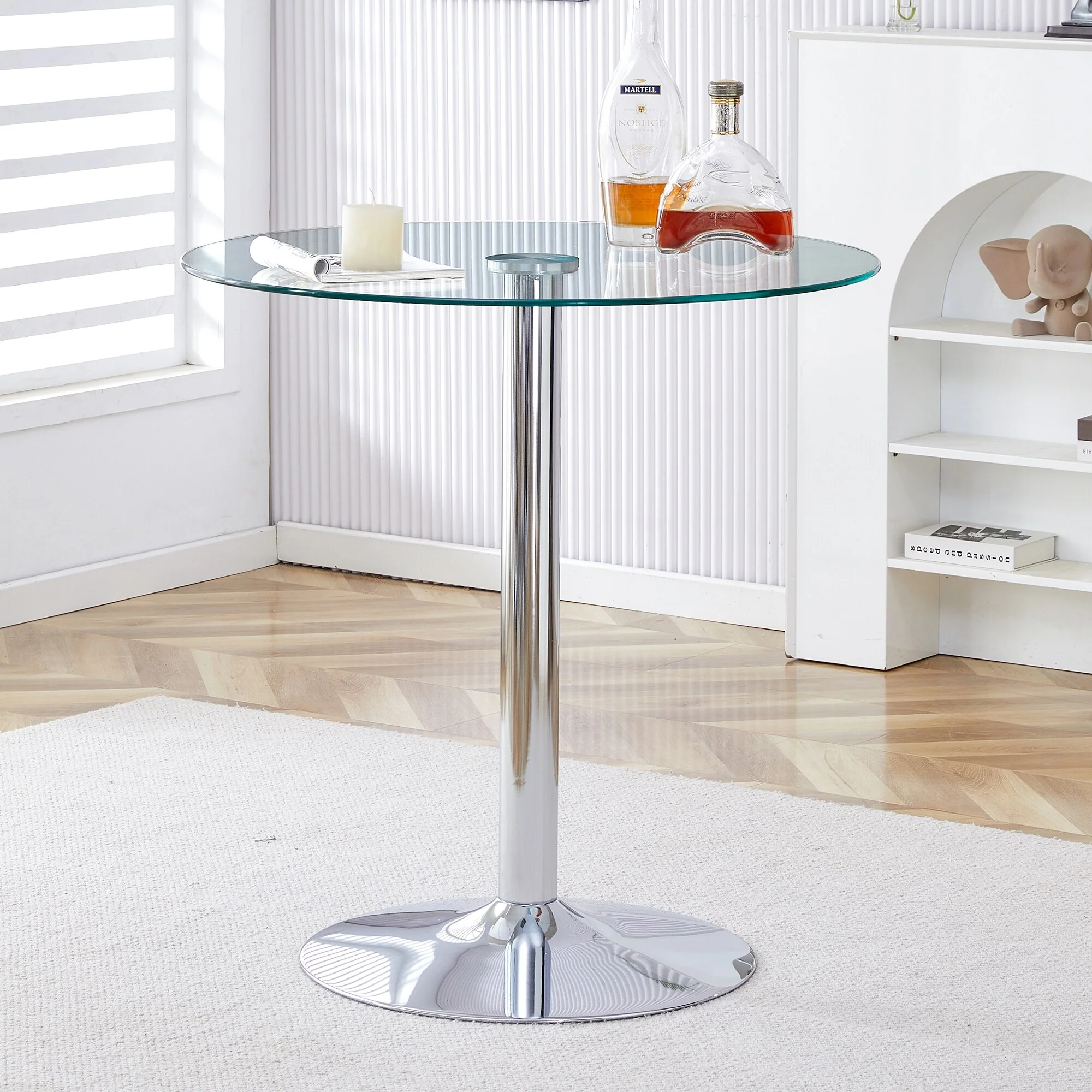 A glass tabletop with a diameter of a modern minimalist circular dining table with electroplated silver metal legs