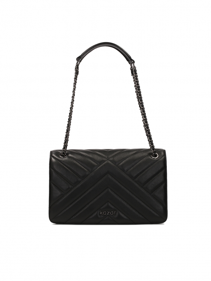 Black ornate handbag suspended from a chain