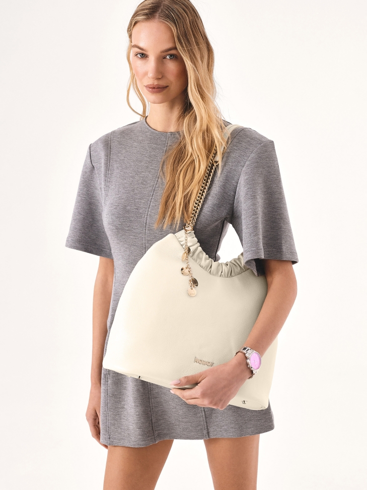 Cream handbag of loose cut with two handles