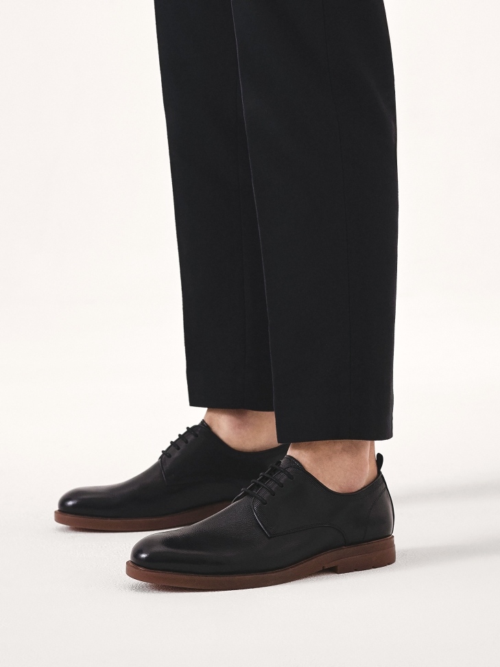 Black leather shoes with brown sole
