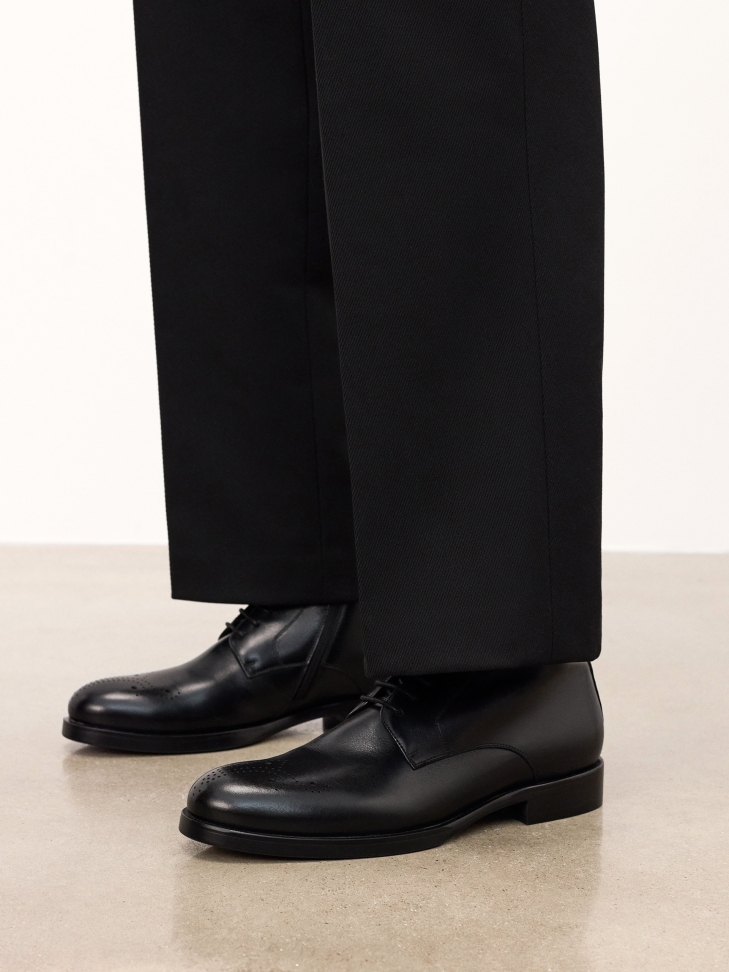 Black smooth leather boots with openwork embellishment