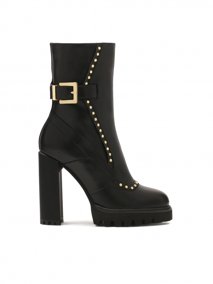 Black boots with round gold rivets
