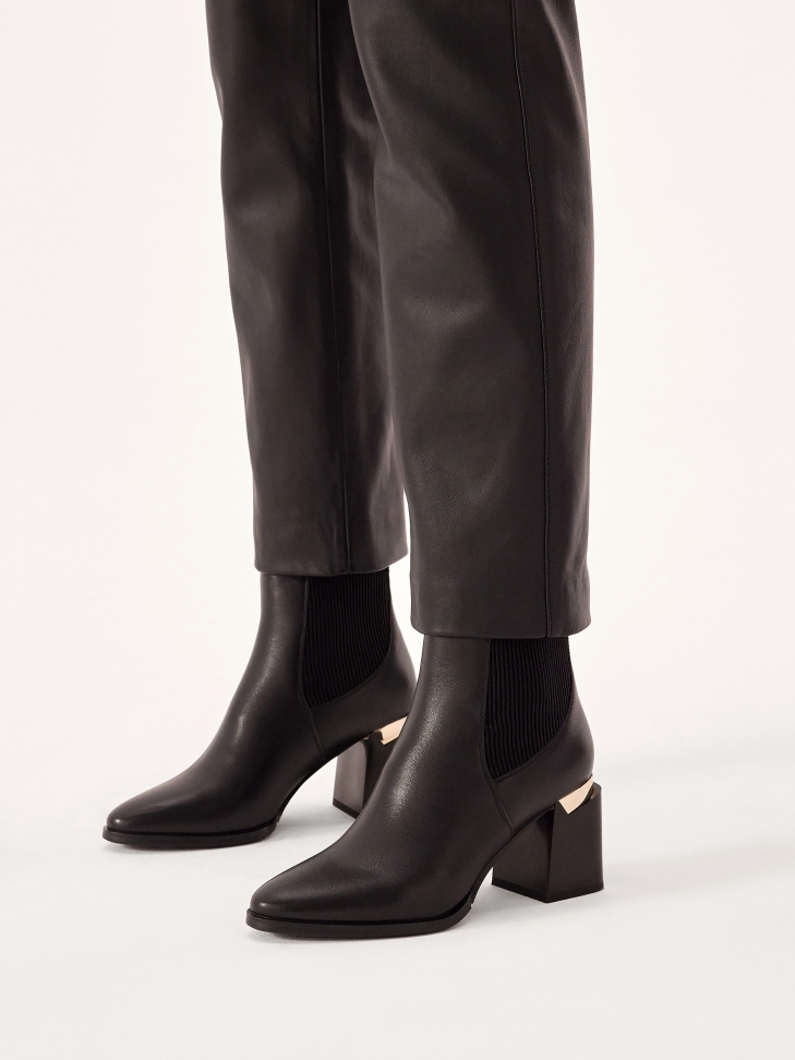Black boots with a wide decorated heel