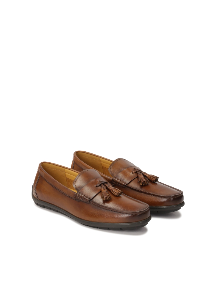 Brown moccasins with a decorative element