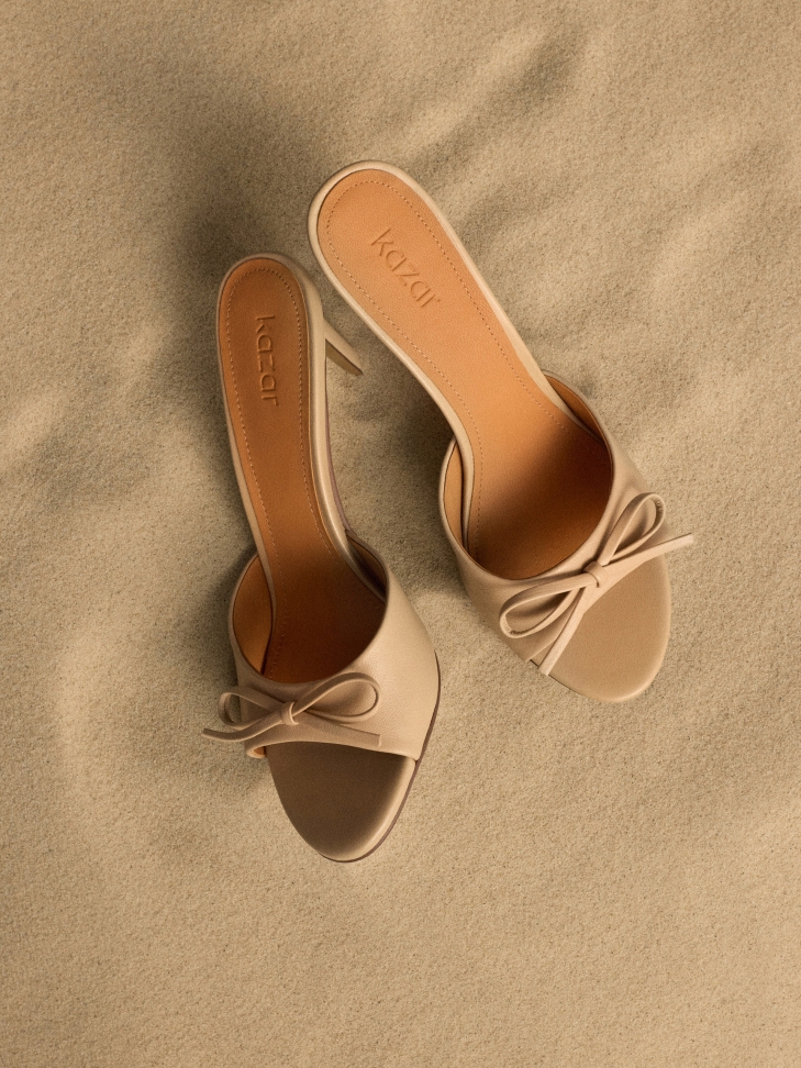 Beige mules with leather bow