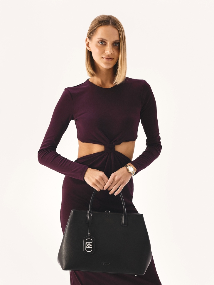 Black leather handbag in minimal style