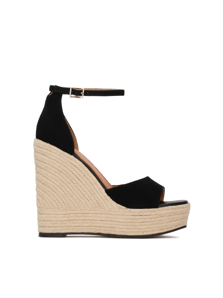 Black suede wedge sandals on a platform