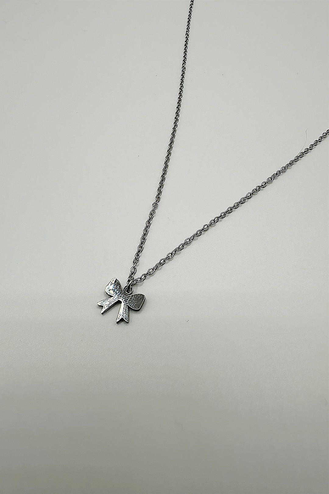 SVNX Mini Bow Pendant Necklace in Silver