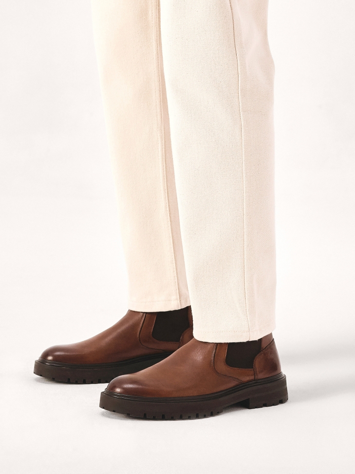 Brown Chelsea boots on a trefoil sole