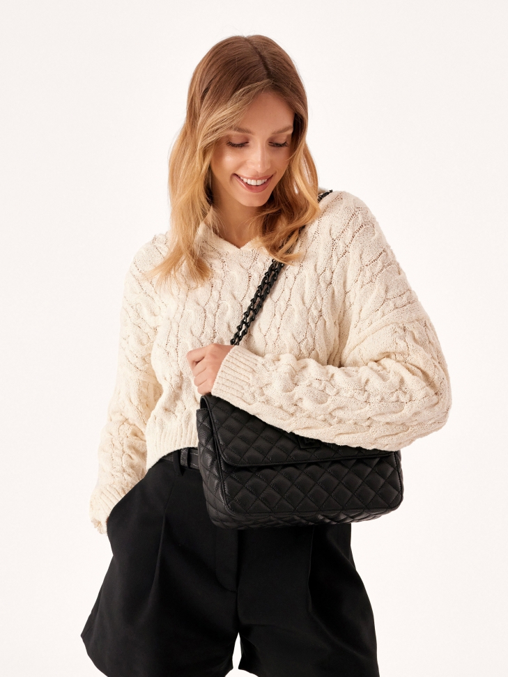 Black leather handbag with quilted oblong shape