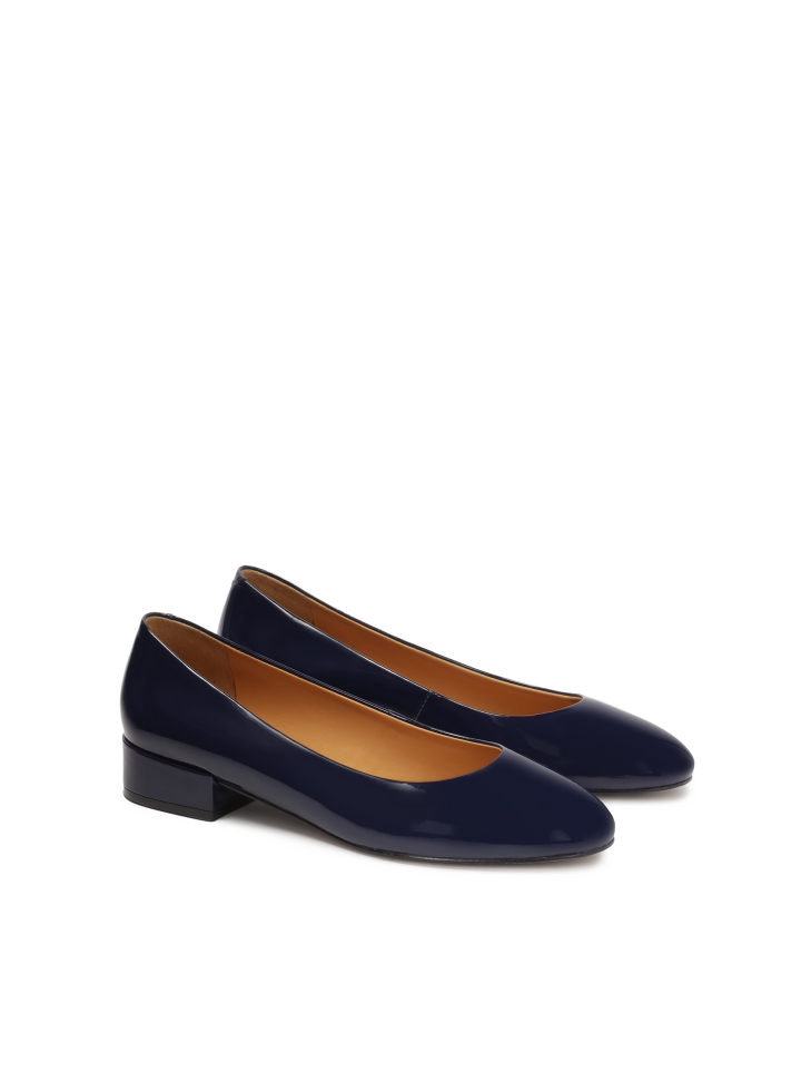 Navy blue patent leather pumps on a post
