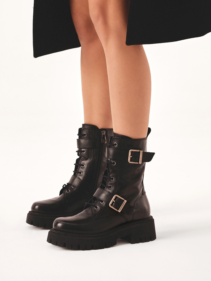 High boots decorated with straps with buckles