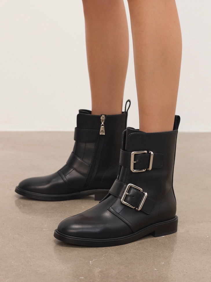 Flat leather boots decorated with buckles