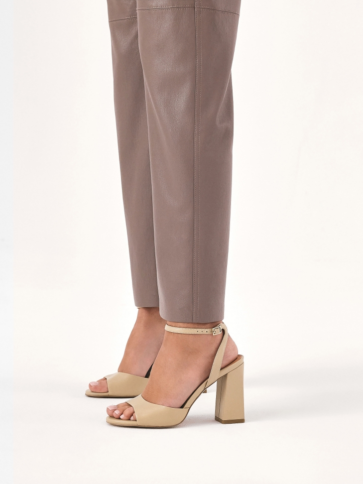 Classic beige sandals on a post