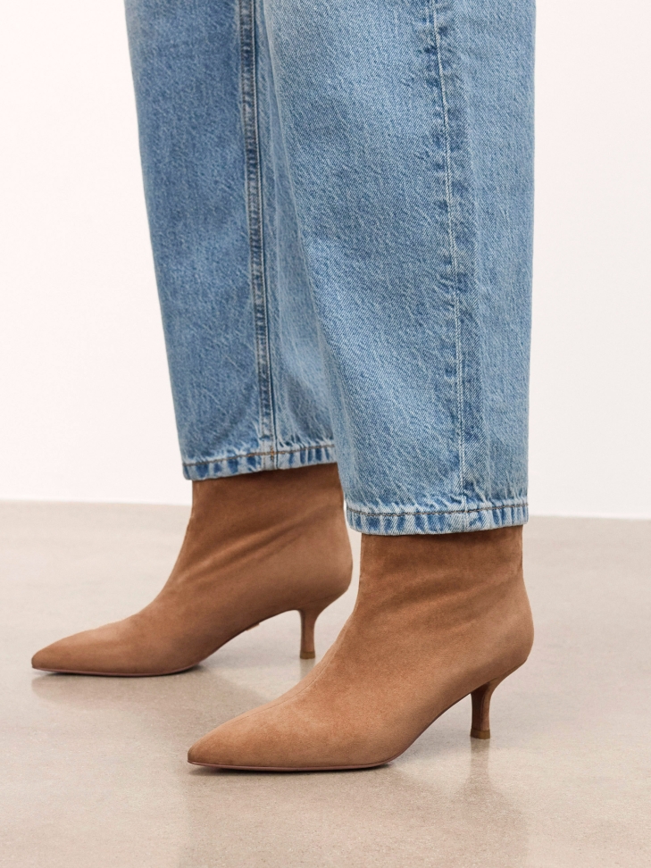 Light brown suede boots on a low stiletto heel