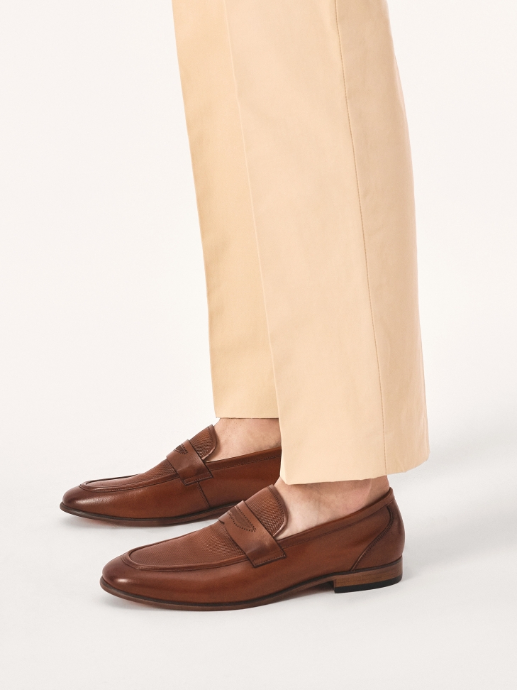 Brown loafers decorated with leather embossing