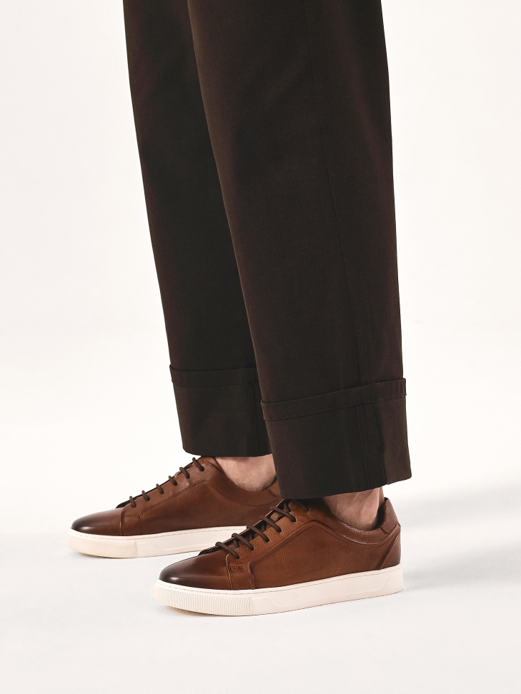 Brown sneakers on a white sole